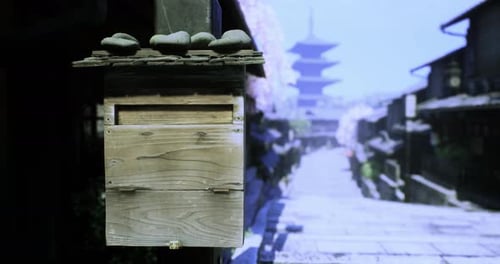Traditional Wooden Mailbox Stands in a Serene Japanese Street During Springtime