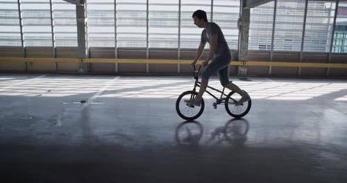 Sportsman Riding BMX Balancing on Stunt Peg
