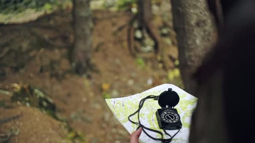 Female Traveler Holding a Compass and Looking for Direction Navigation Search Path or Road