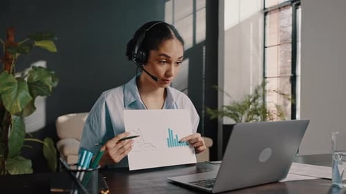 Young Woman Presenting Data Graph in Office