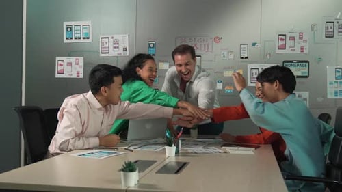 Diverse Team Celebrates Success at Office Meeting