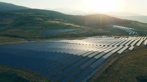Dolly in shot of Solar panel rows, Photovoltaic panels farm at sunrise