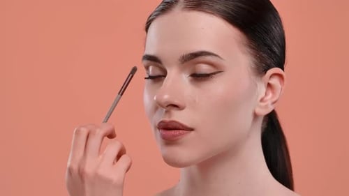 Young Adult Applying Eye Shadow Close Up