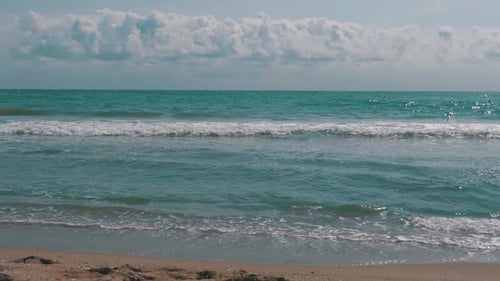 The Sea Waves are Rolling on a Sand Beach