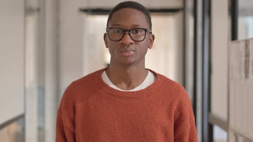 Man with glasses and orange sweater
