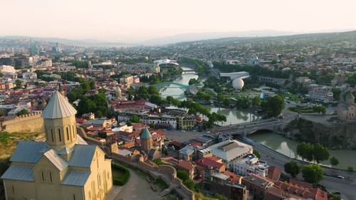 Narikala Fortress and Old Town of Tbilisi Cityscape in Georgia - aerial drone shot