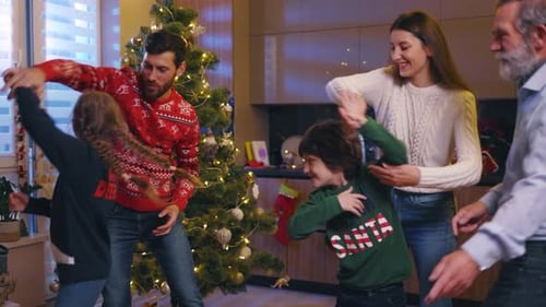 Family Dance Around Christmas Tree on Christmas Day