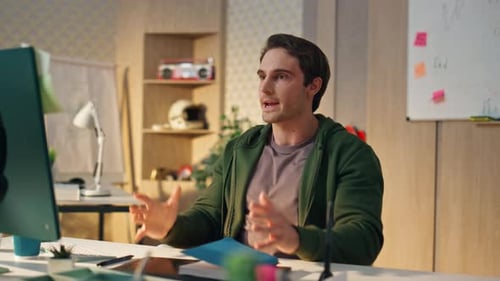 Young Adult Man Working at Computer in Office