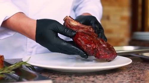 Chef Places Delicious Steak on White Plate