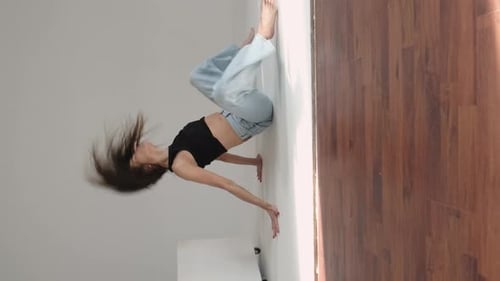 Female Dancer Leaning to the Side with a Leg Lifted Showcasing Grace and Strength in a Studio
