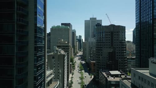 4K Cinematic urban drone footage of an aerial view of a boulevard in the middle of downtown Montreal