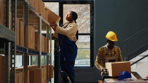 Warehouse Workers Taking Inventory with Laptop