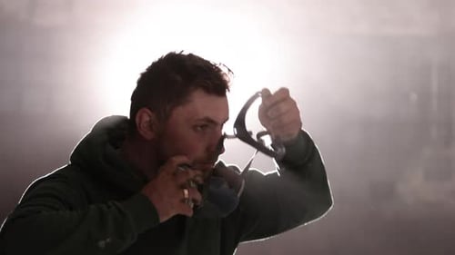 Man Puts on Full Face Respirator Mask