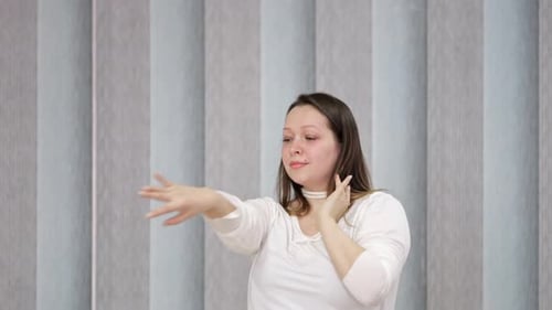 Woman Dancing Indoors With Fluid Arm Movements