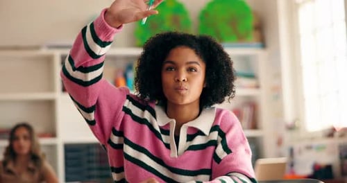 Student Raises Hand in Sunny Classroom Environment