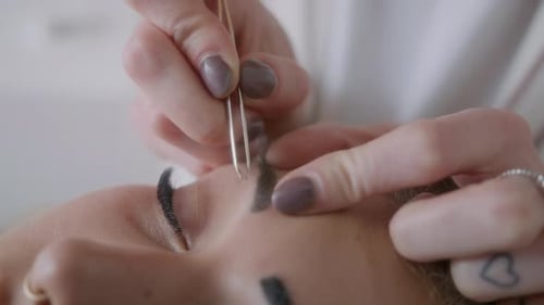 Woman Receiving Eyebrow Waxing Treatment Close Up