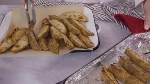 Freshly Baked Potato Wedges with Spices on a White Serving Tray