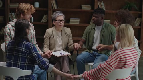 Diverse Group in Therapy Circle Holding Hands