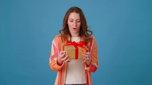 Young Woman Catches and Opens Birthday Present