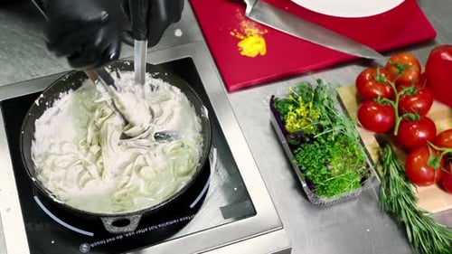 Pasta Preparation with Cream Sauce and Fresh Ingredients