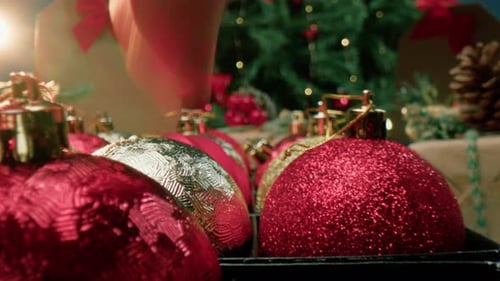 Hand Picking Christmas Balls for Decoration