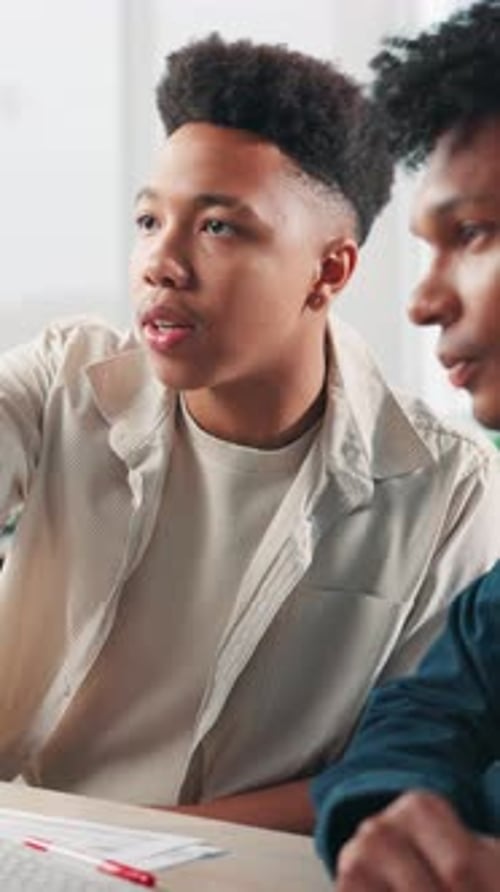 Two Young Men Discussing Business Inside