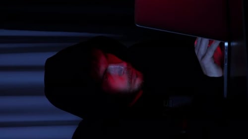 Male hacker working on laptop computer