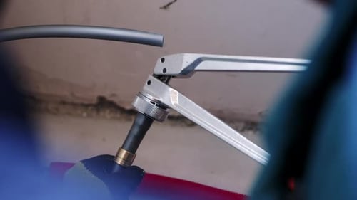 Plumber Using Pipe Expander Tool on Plastic Pipe