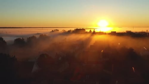 Fog on an Autumn Morning in the Village Under Bright Sunlight