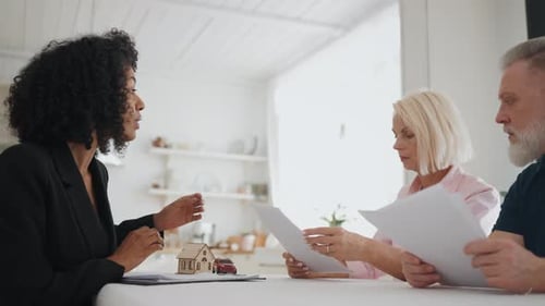 People Discussing Agreement of Buy or Sale Property Woman Real Estate Agent African American Broker