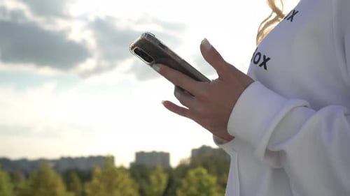 Young Adult Using Smartphone in Urban Setting