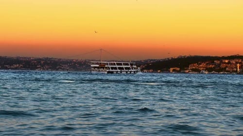Tour Boat Crossing River at Sunset