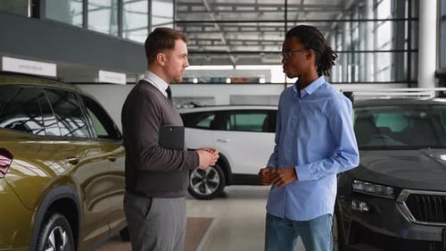 Car Salesman Meeting with Customer in Showroom