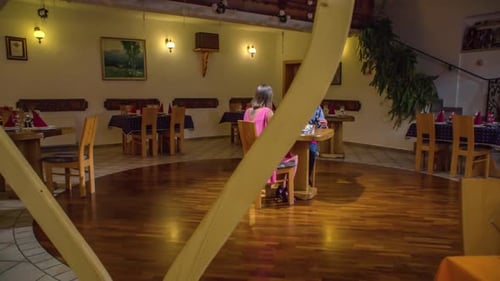 Couple having exclusive romantic dinner at rustic and vintage restaurant. Spinning wide angle shot.