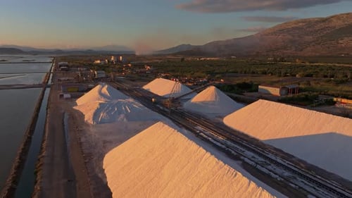 Aerial view of salt pans and factory at sunset, Greece.