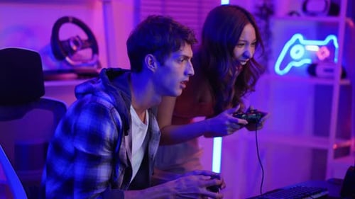 Couple Playing Video Game in Neon Lit Room