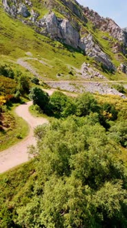 Ground road in the picturesque mountains. Stunning rocky landscape on sunny day.