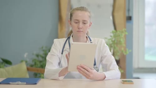 Female Doctor using Tablet in Clinic