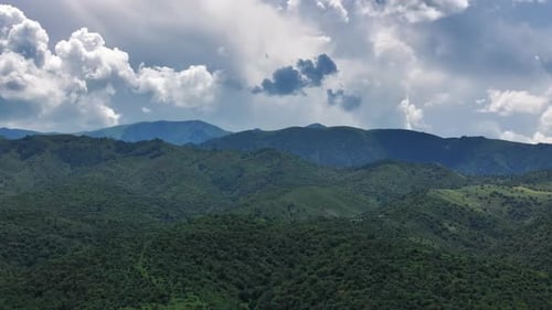 Mountain Hills Under A Dramatic Sky. Cloud Shadows Over Green Slopes