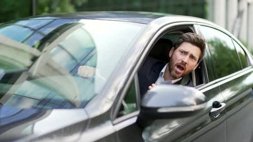 Upset Man Arguing in Car, Gesturing Angrily
