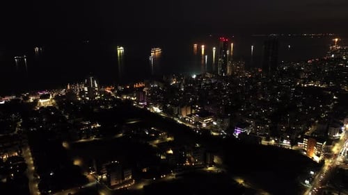 Coastal Cityscape Shines at Night from Above