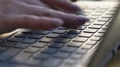Woman's Hands Typing on Laptop Keyboard Close Up