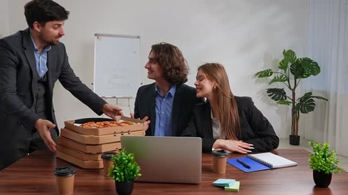 Business Team of Men and Woman Working at Desk in the Office Having Dinner Break with Food Delivery