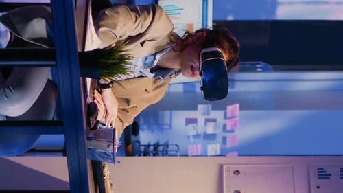 Vertical Video Young Worker Wearing Virtual Reality Goggles in Office