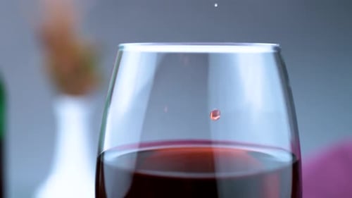 Wine Dropping into a Full Wine Glass