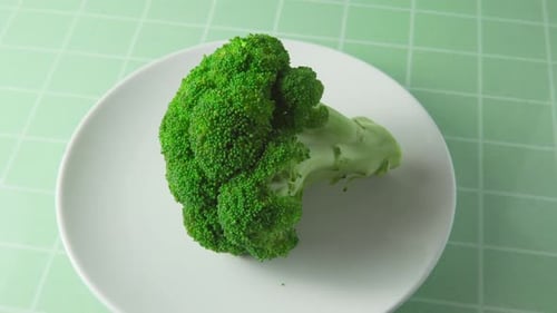 Close-up view of fresh broccoli. Green cabbage on white plate
