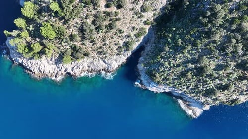 Aerial View of Turquoise Ocean with Rocky Coastline