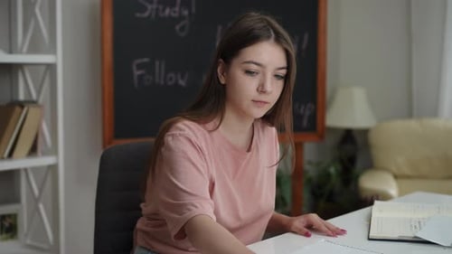 Teenage Girl Doing Homework At Her Desk