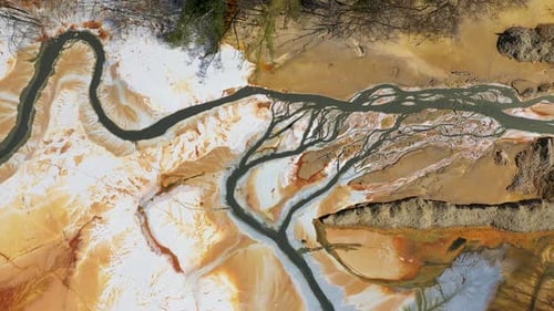 Aerial view of acidic mine residual water drainage, flowing into decanting pond