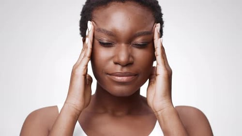 Woman Massaging Temples Experiencing Headache Pain Close Up